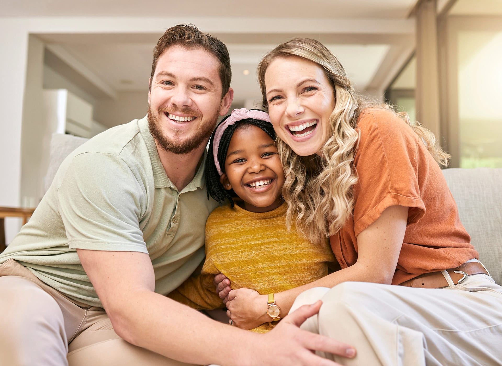 Mom and dad with their adopted child.