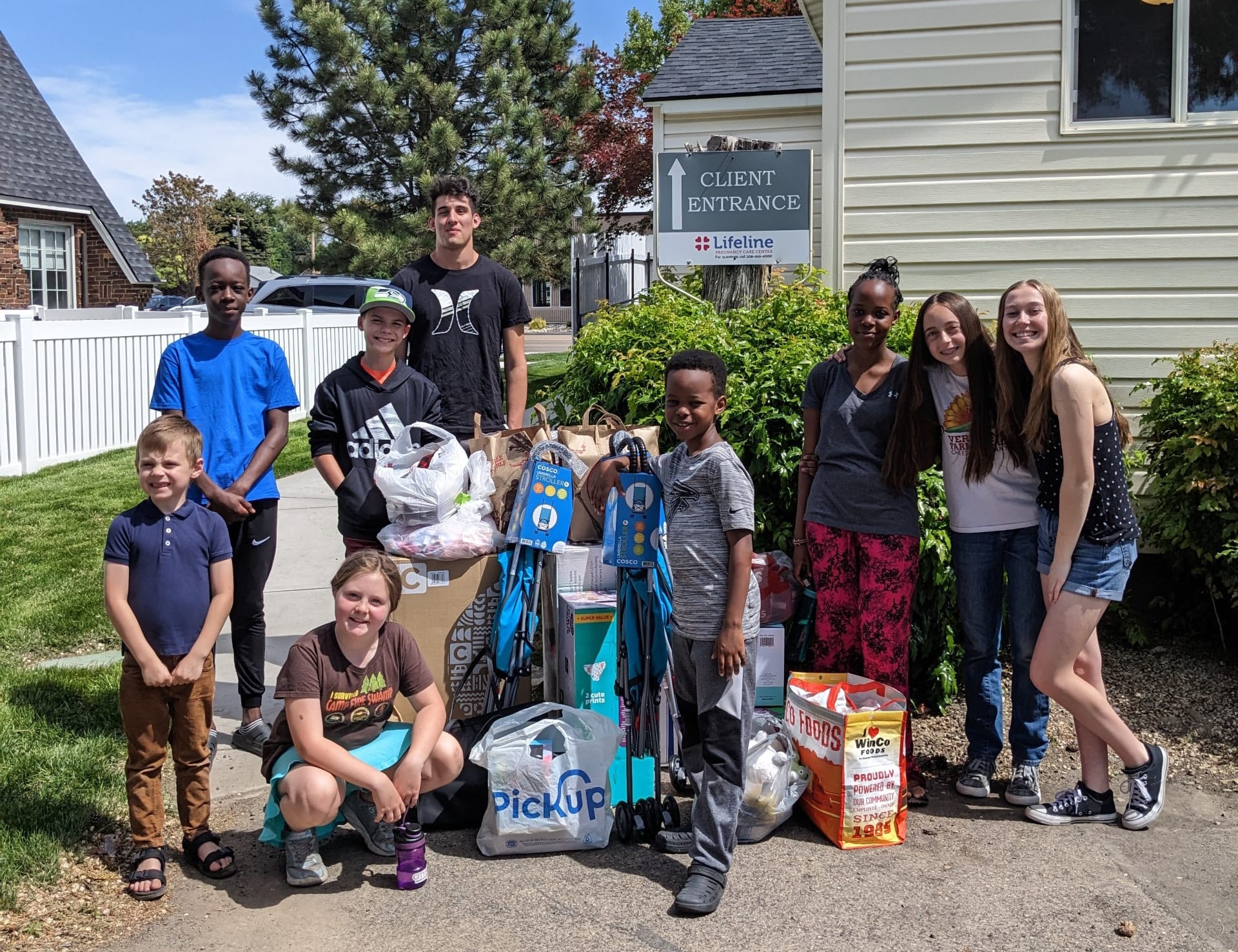 Youth standing in front of Lifeline Pregnancy center in Idaho after donating baby items.