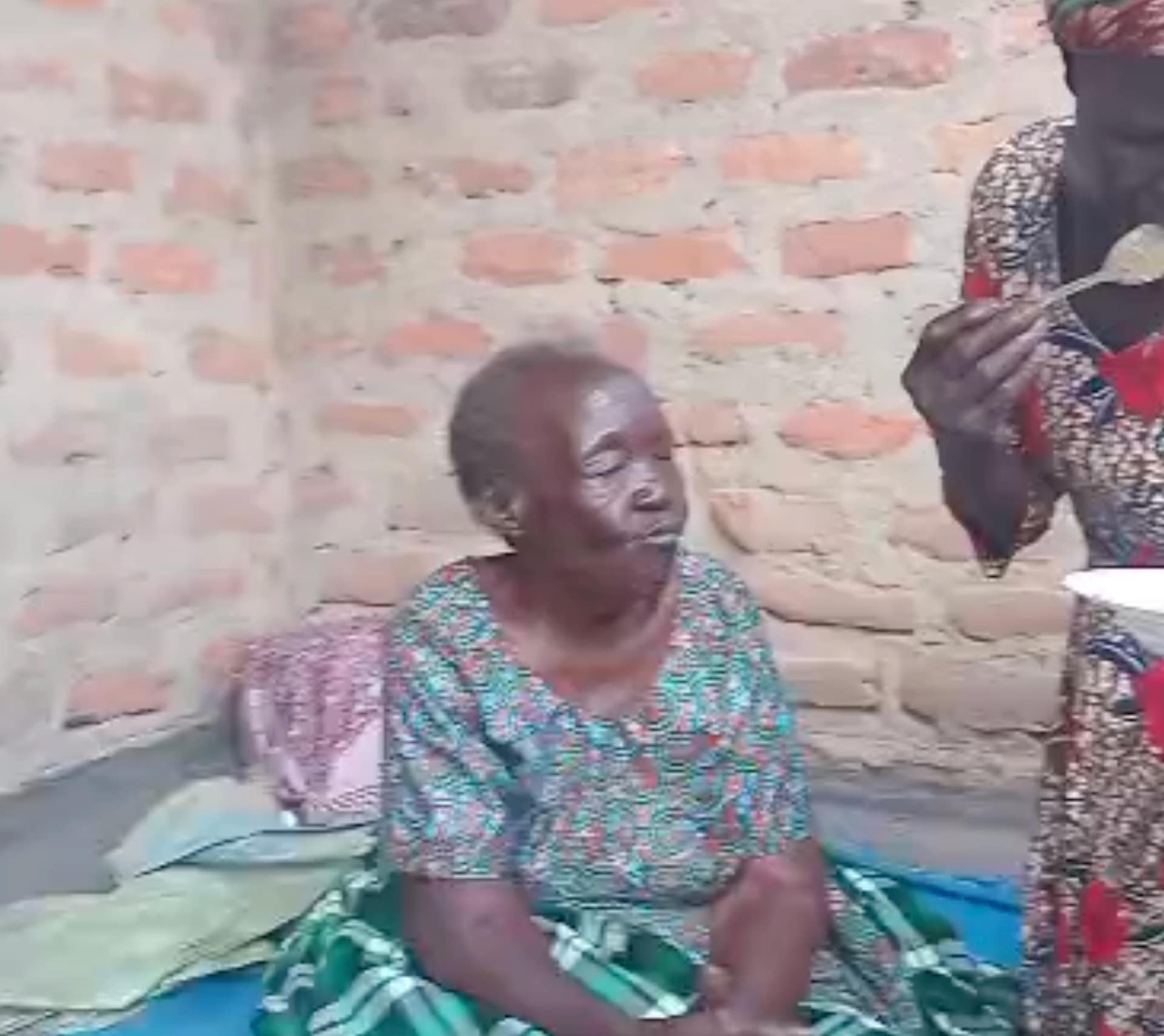 Elderly woman sitting outside